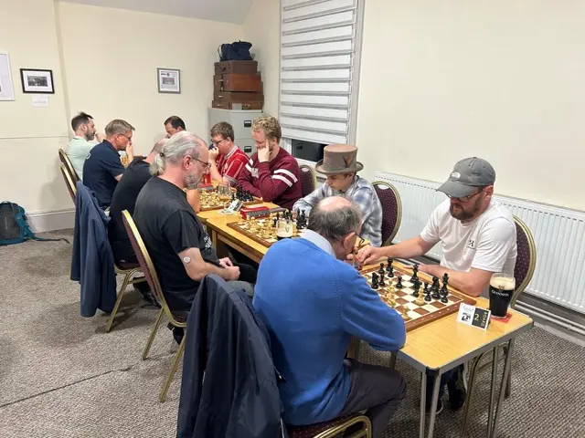 Players at board 2 in the foreground with the rest of the room behind
